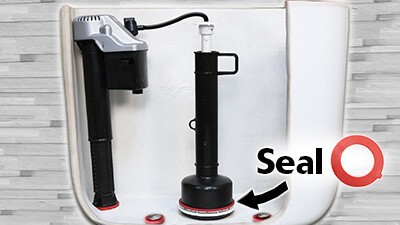 this image contains a fill valve and canister inside a toilet tank